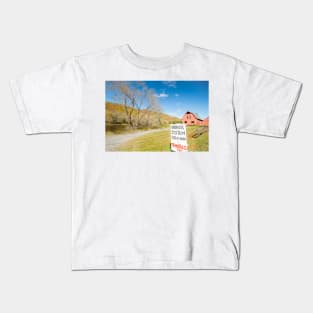 Honor system sign for tomatoes in rural New England beside an American style red barn by a river. Kids T-Shirt